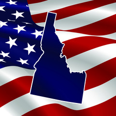 United States, Idaho. Dark blue silhouette of the state on its borders on the background of the USA flag.
