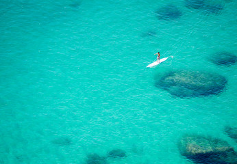 Stand up paddle board over turquoise sea at Poetto Cagliari Sardegna Italy