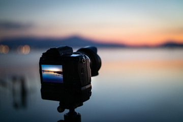 Landscape photoshoot camera on tripod at sunset