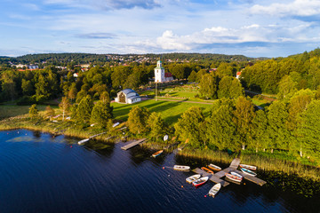 Boats at lake in front of church