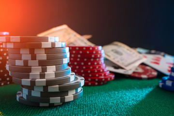 Naklejka premium Casino chips on the gaming table. For poker, with creative light.