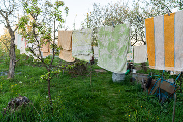 Kitchen towels hanging on a rope in the backyard in the village