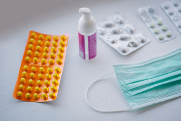 atiseptic pills and medical mask lie on a white background