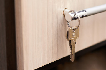 Close-up of metal keys and keychain at home and in the office. Security concept against hacking of apartments and apartments