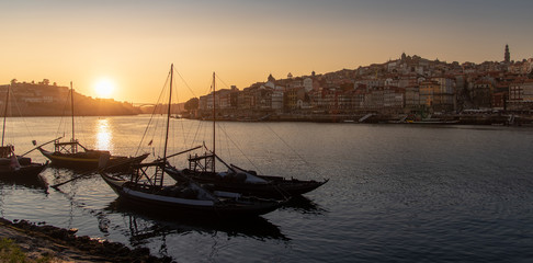 Porto cityscape in sunset with river on the front and wine carrier ship in  foreground and city of Porto in background, Portugal - 346638269