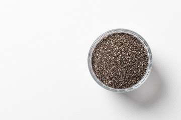 Chia seeds in a cup beautifully laid out on a white background. Top view. copy space.. Vegetarian food.