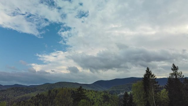 Time lapse of massive rainy clouds moving over the mountains