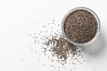 Chia seeds in a cup beautifully laid out on a white background. Top view. copy space.. Vegetarian food.
