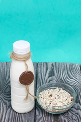 Bottle of milk. On the neck of the bottle is twine with a wax locket. Next to the granola in the...