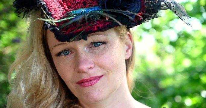 Closeup blond woman with historic costume with hat blue eyes blond hair