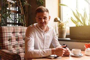 Happy man is resting in coffee shop