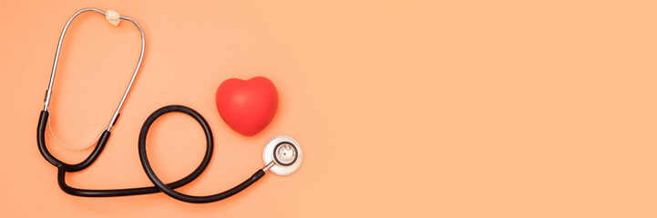 A heart with a stethoscope on red background