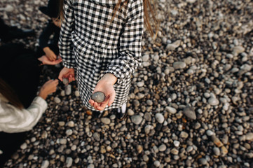 A beautiful young family on the sandy shore of the ocean relaxing and have a fun