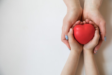 Heart in hands on light background. Healthcare background.