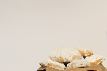 Homemade fresh cookies dusted powdered sugar in plate on white background, traditional cyprus turkish 'kurabiye', copy space
