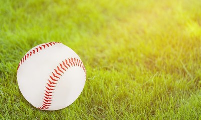 Baseball ball with seams on the green grass