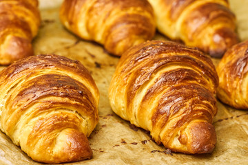 Puff pastry croissants with chocolate on baking sheet. Homemade cooking. Concept of international cuisine. 