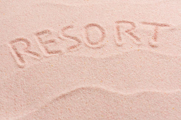 Fototapeta na wymiar RESORT lettering on sand with wave. Minimal exotic Sand, shells, vacation and travel concept, Flat lay top view copy space