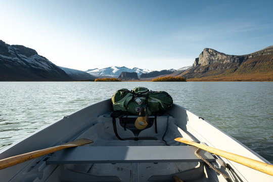 canoe crossing a lake in the swedish arctic