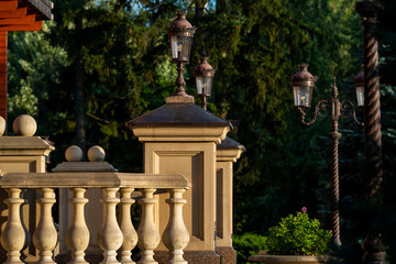 Fototapeta na wymiar street lamp on the stone pillars of the balustrade in architecture, balusters