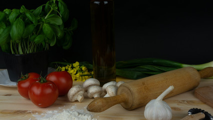 
composition of vegetables, mushrooms, oil, basil, tomatoes