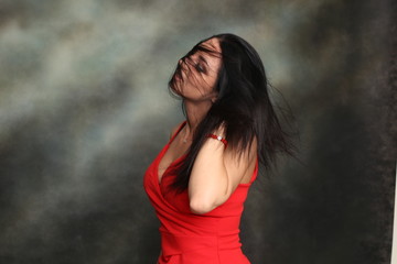 Beautiful, fancy glamourous caucasian girl with black hair posing in studio. Style, trends,...