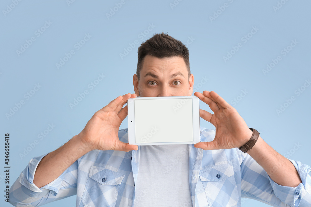 Poster handsome man with tablet computer on color background