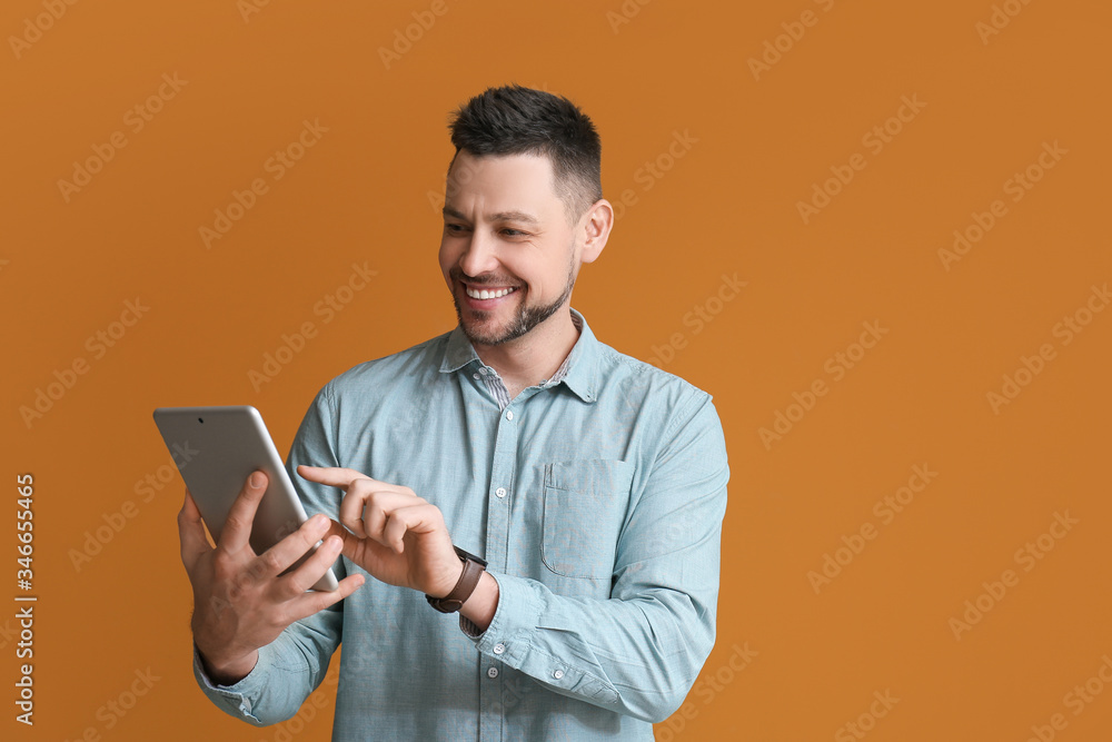 Poster handsome man with tablet computer on color background