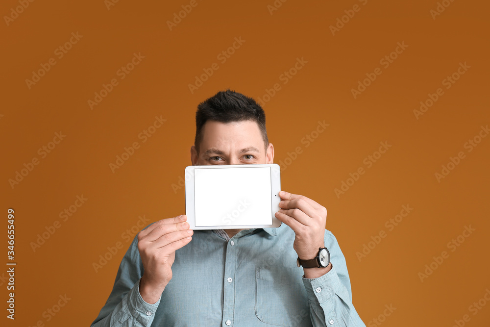 Aufkleber handsome man with tablet computer on color background