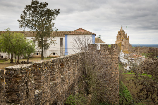 Castle wall with a view to the clock tower - castle of Montemor-O-Novo, District of Evora, Alentejo, Portugal