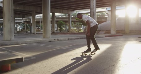 African American skateboarder at skate park - Powered by Adobe