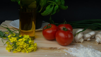 
composition of vegetables, mushrooms, oil, basil, tomatoes