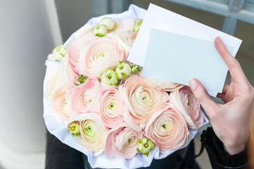 Bouquet of flowers. Pink ranunculus in a round cardboard box.