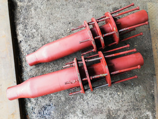 Red painted stainless steel pipe expansion oil seal joints with control rods for steam and heat...