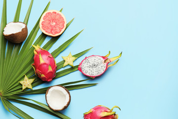 Tasty exotic fruits on color background