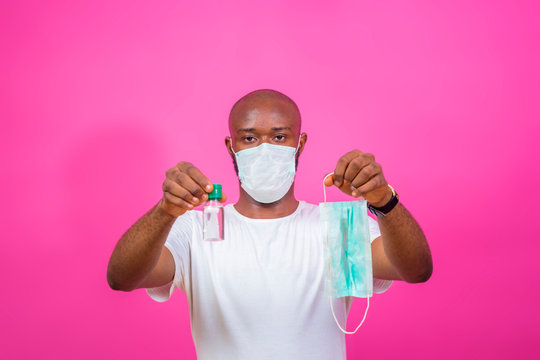 young black african man wearing face mask influencing people to use face mask and hand sanitizer