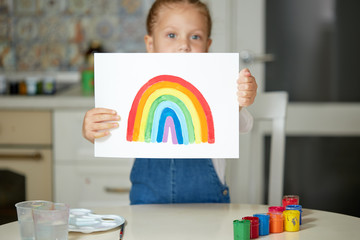 Thank to NHS. Kid painting the rainbow during Covid-19 quarantine at home. coronavirus covid-19 outbreak.