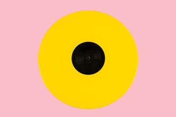 Yellow vinyl disk on a pink background 
