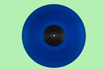 Blue vinyl disk on a green background 