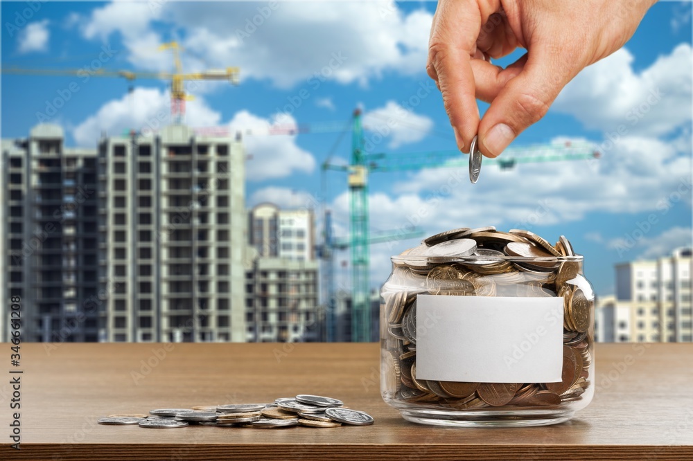 Sticker Hand putting coins in a glass jar with a blank label