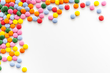 Color candy on white background top view frame copy space