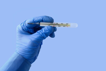 Extremely accurate mercury thermometer in the doctor’s hand shows elevated temperature on a...