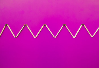 Geometric pattern on a purple background from matches. Development Learning Concept