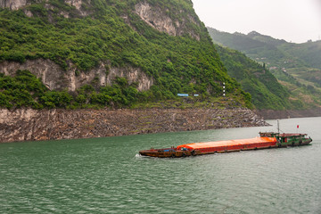 Zigui, China - May 6, 2010: Xiling gorge on Yangtze River. Landscape of Green mountain slopes along...