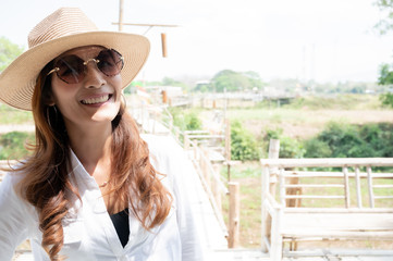Asian woman with wooden bridge background