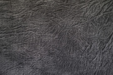 Dark rough texture with abstract streaks on the textile base. Gray background with texture divorces.