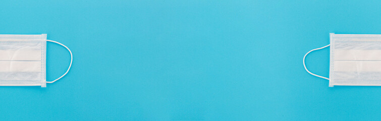 Top view of two medical surgical masks at the edges. Banner of a disposable doctor's respirator with copy space for text