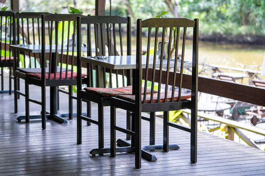 Chairs And Table On The Backyard In Tropical Cafe Near Lake With Beautiful View