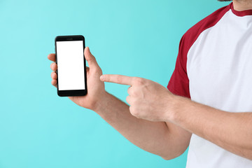 Man with mobile phone on color background