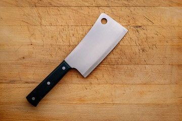 butcher's ax on a wooden cutting board